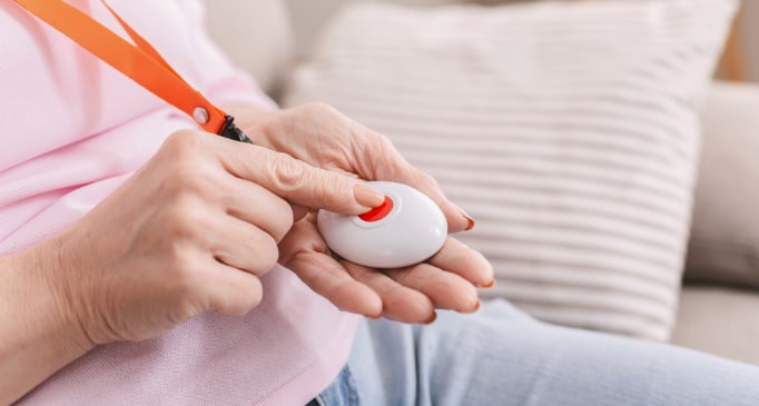 Woman pressing button of medical alert system
